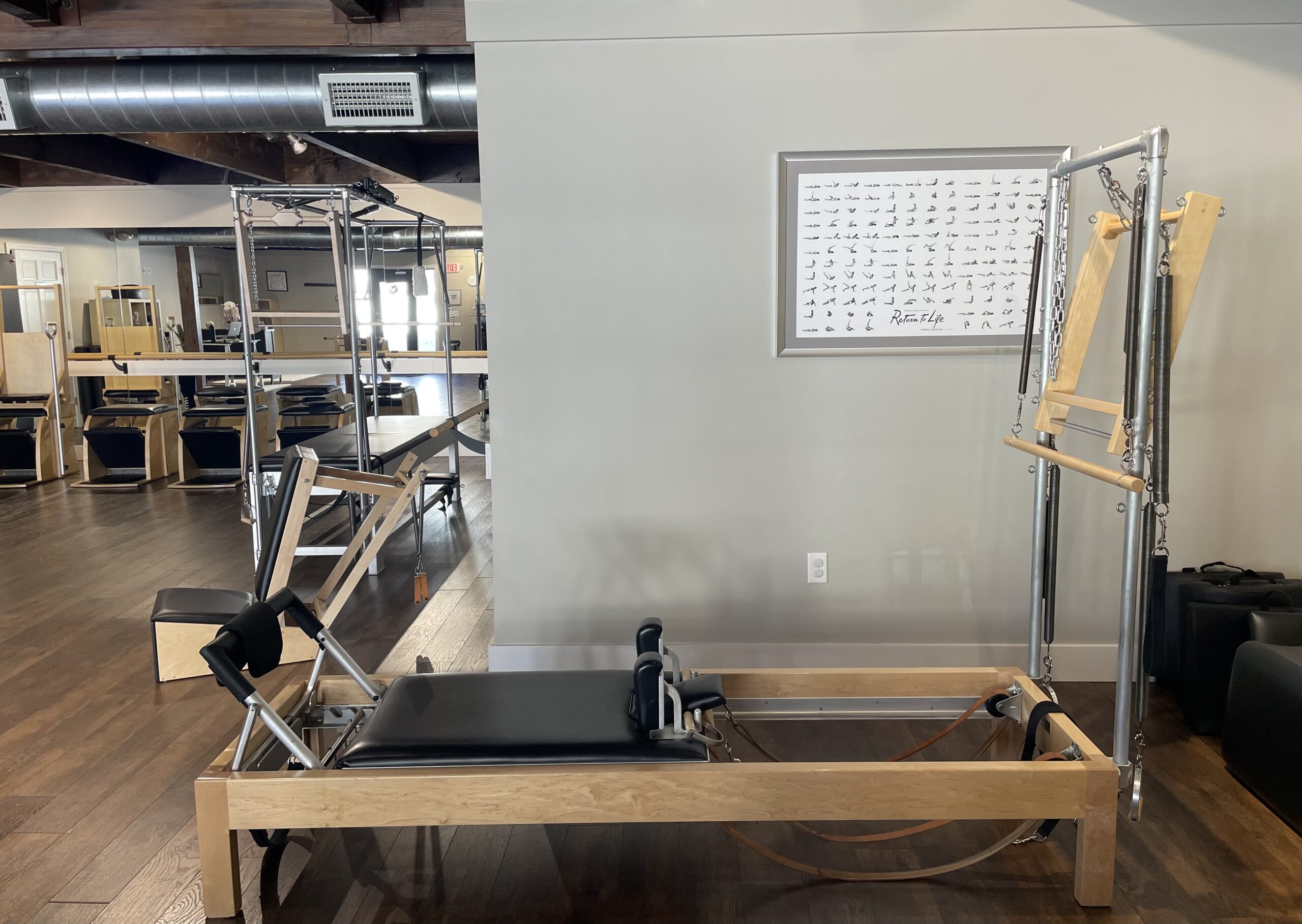 mindy with a class attendee during pilates class